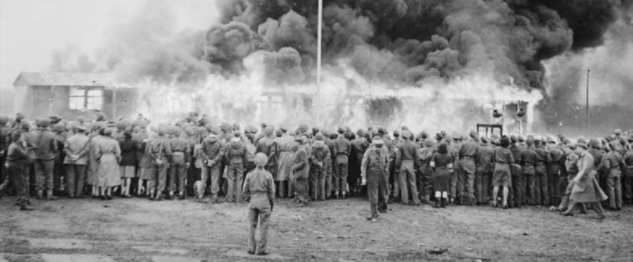 The Liberation of Bergen-belsen Concentration Camp, May 1945. Crowds watch the destruction of the last hut at Belsen two days after the camp was finally evacuated. The hut was set on fire by a British flamethrower.