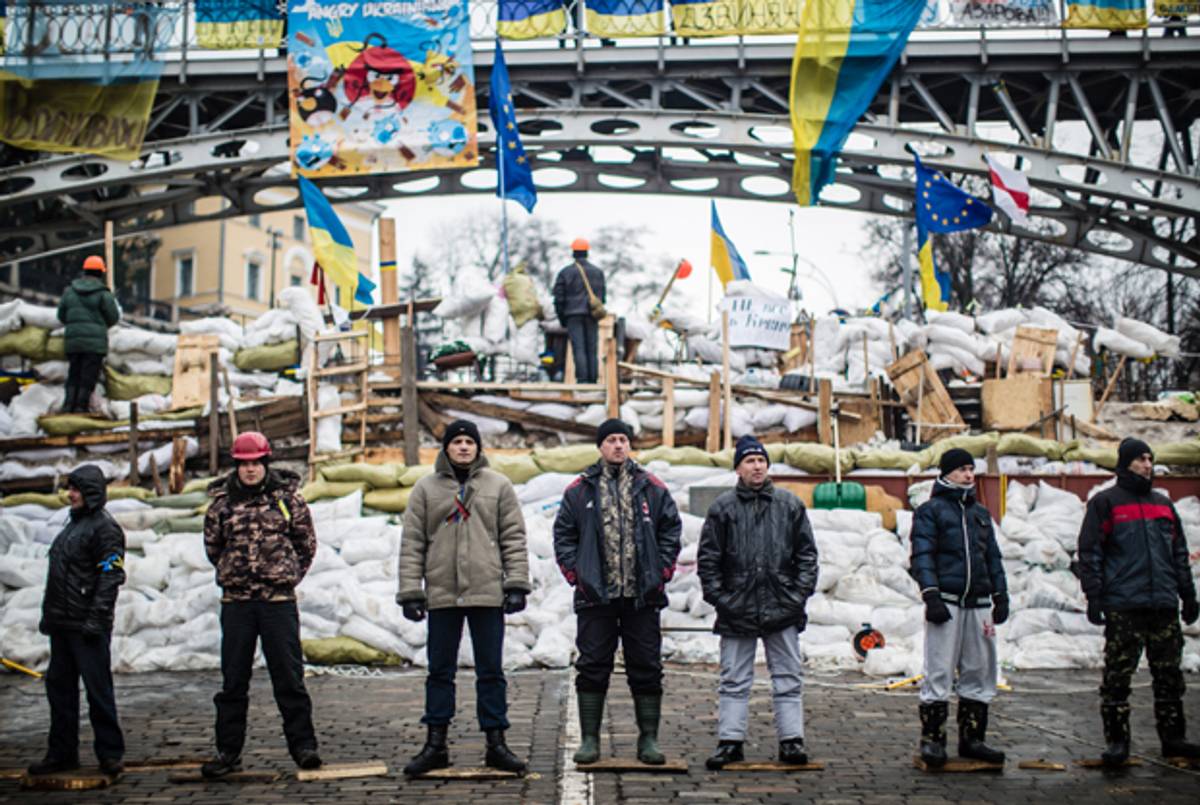Anti-government protesters guard a barricade designed to keep police from evicting them from Independence Square on December 13, 2013 in Kiev, Ukraine.(Brendan Hoffman/Getty Images)