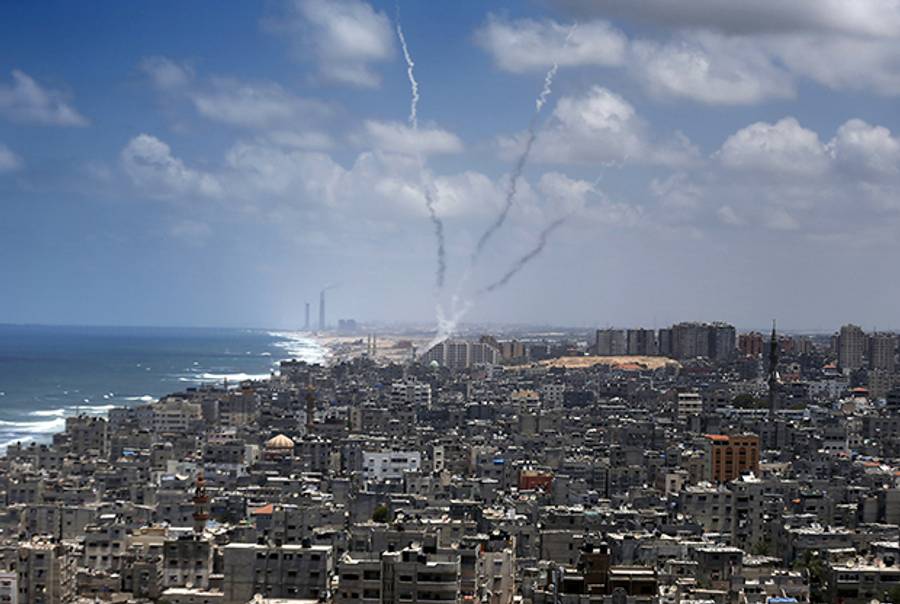 Smoke from rockets fired from Gaza City are seen after being launched toward Israel, on July 15, 2014. (THOMAS COEX/AFP/Getty Images)