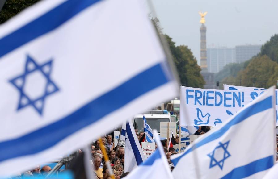 Israeli flags and a banner with the word ‘Peace’ in German fly in front of the Siegessaule, or Prussian Victory Column, during a rally in Berlin against antisemitism on Sept. 14, 2014
