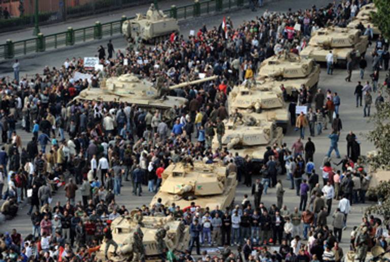 Tanks and protestors in the streets of Cairo yesterday.(Miguel Medina/AFP/Getty Images)