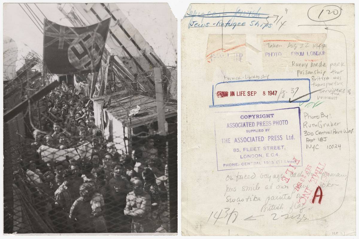 1,500 refugees, having been forced off Exodus 1947 in Haifa and sent to Port de Bouc near Marseilles, France, wait aboard the British prison ship Runnymede Park. Protesting their imprisonment, the survivors painted a swastika on top of the Union Jack, August 22, 1947. (© Estate of Ruth Gruber, International Center of Photography)