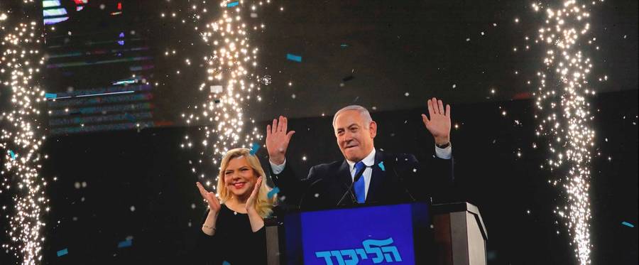 Israeli Prime Minister Benjamin Netanyahu, accompanied by his wife, Sara, greets supporters on election night at his Likud Party headquarters in Tel Aviv early on April 10, 2019. 