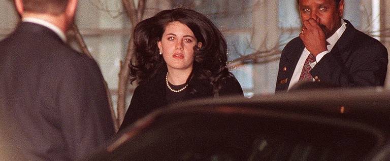 Monica Lewinsky (C), the former White House intern who allegedly had an affair with US President Bill Clinton, walks to a waiting car 29 January at the Cosmos Club in Washington DC. 