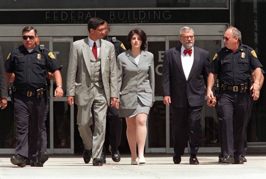  Former White House intern Monica Lewinsky is escorted by police officers, federal Investigators, and her attorney as she leaves the Federal Building in Westwood, California on May 28, 1998. (VINCE BUCCI/AFP/Getty Images)