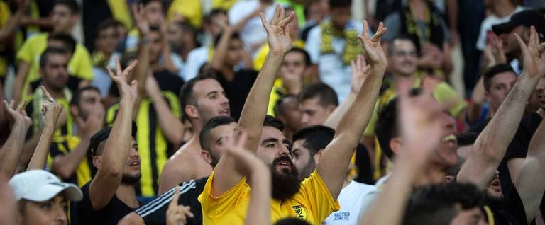 Supporters of Israeli football club Beitar Jerusalem make offensive gestures with their hands during their club's return match against Belgium team Charleroi on July 23, 2015, at Teddy Stadium in Jerusalem.