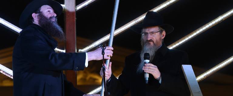 Rabbi Berel Lazar (R) lights candles at the menorah marking the start of Hanukkah in central Moscow. Rabbi Lazar is the Chief Rabbi of Russia.