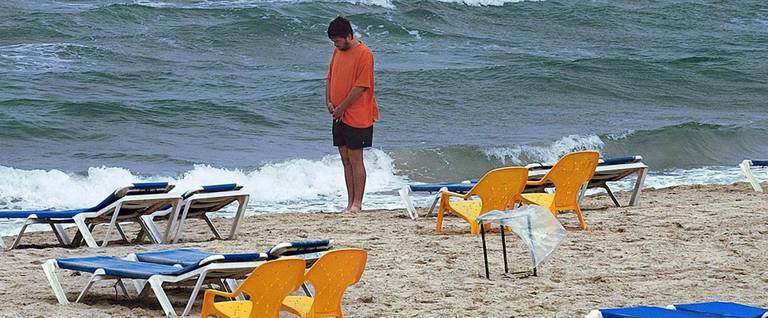 An Israeli observes two minutes of silence 19 April 2004 on a Tel Aviv beachfront to pay tribute to victims of the Nazi genocide on the annual Holocaust memorial day.