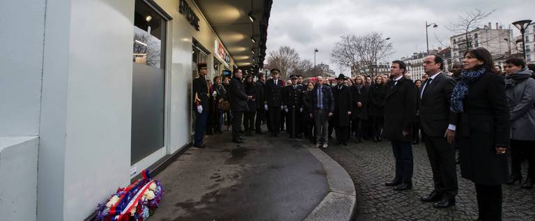 French President Francois Hollande (C), French Prime Minister Manuel Valls (L) and Mayor of Paris Anne Hidalgo (R) pay tribute to the victims of the January 2015 attack on the Hyper Cacher kosher supermarket, January 5, 2016. 
