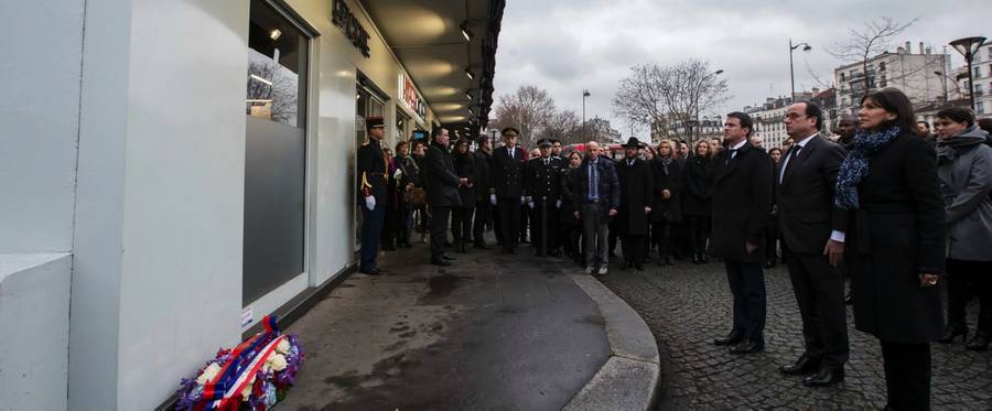 French President Francois Hollande (C), French Prime Minister Manuel Valls (L) and Mayor of Paris Anne Hidalgo (R) pay tribute to the victims of the January 2015 attack on the Hyper Cacher kosher supermarket, January 5, 2016. 