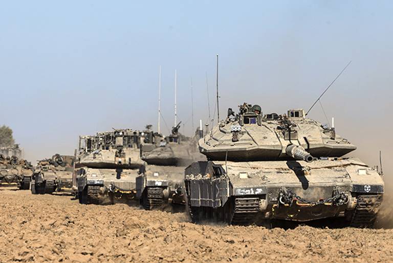 Israeli Merkava tanks, a D9 bulldozer and armoured personnel carriers (APC) roll near Israel's border with the Gaza Strip on July 17, 2014. (JACK GUEZ/AFP/Getty Images)