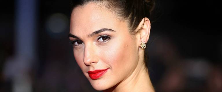 Israeli actress Gal Gadot poses for a photograph after arriving to attend the European Premiere of the film 'Batman v Superman: Dawn of Justice', in London, March 22, 2016. 