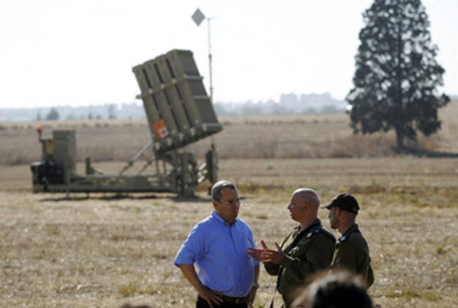 Defense Minister Barak in front of an Iron Dome launcher.(David Buimovitch/AFP/Getty )