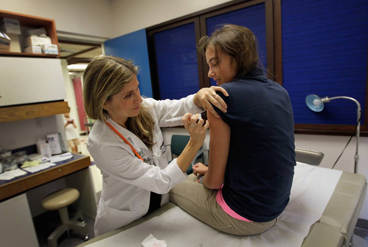 University of Miami pediatrician Judith L. Schaechter gives an HPV vaccination to a 13-year-old girl in her office at the Miller School of Medicine on September 21, 2011.(Joe Raedle/Getty Images)