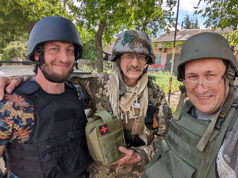 Boris Zakharov (left) at the frontline near Izium, in the Kharkiv region, in late May, with Boris Redin, a volunteer (right), and Leonid Onishchenko, a member of the Ukrainian Armed Forces (center)