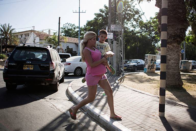 People run for shelter during a 'color red' siren on July 10, 2014 in Sderot, Israel. (Ilia Yefimovich/Getty Images)