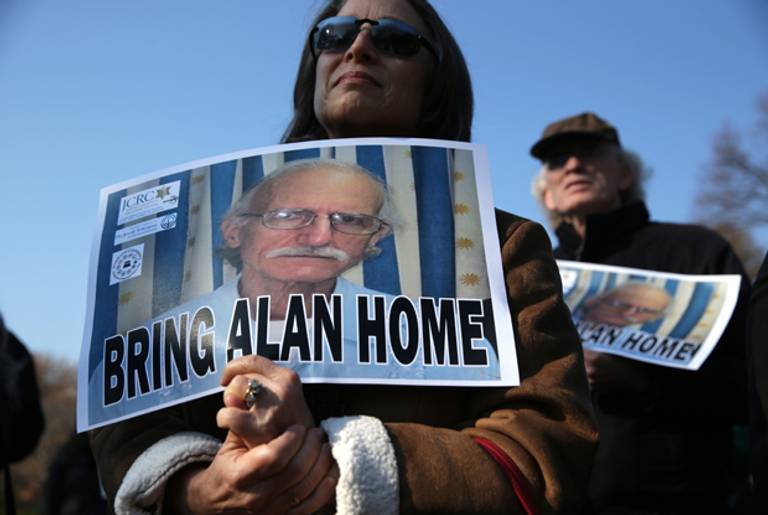 Supporters outside the White House hold signs calling for U.S. citizen Alan Gross, currently being held in a Cuban prison, to be brought home, December 3, 2013. (Alex Wong/Getty Images)