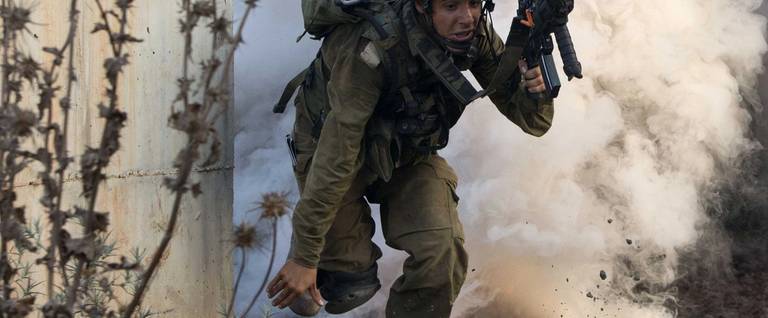 An Israeli infantry soldier from the Kfir Brigade takes part in a drill in urban warfare simulating a combat mission with Lebanon's Hezbollah at the Israeli army base of Elyakim in northern Israel on July 11, 2013. Israeli military built the training base at Elyakim to train soldiers on how to fight Hezbollah as Israel bolsters security along its border with Syria, where Hezbollah militants are reportedly fighting alongside government forces against rebels.