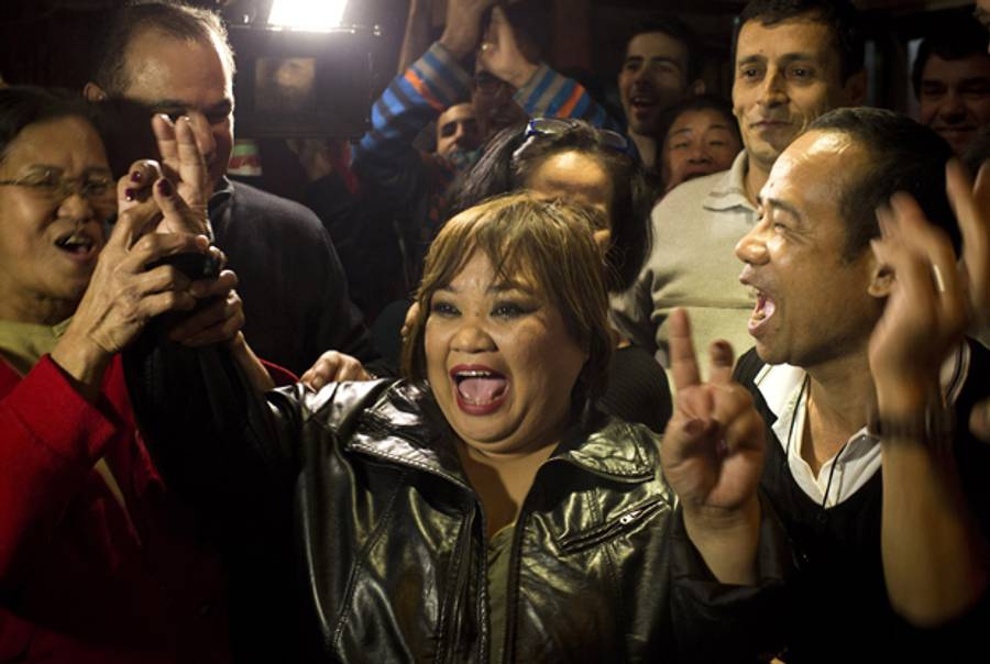 Rose Fostanes, a Filipina migrant caregiver living in Israel, celebrates with friends and family in a bar in South Tel Aviv, after she won in the Israeli X-Factor Television show singing contest, in the early hours of January 15, 2014. (OREN ZIV/AFP/Getty Images)