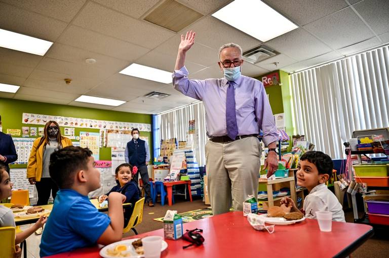 U.S. Sen. Charles Schumer interacts with children at Marks of Excellence Child Care in Amityville, New York, on April 7, 2021.