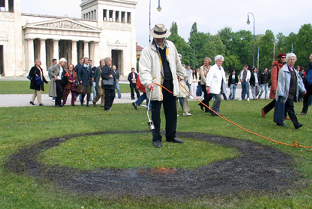 Wolfram Kastner burns a black circle into the Königsplatz lawn in Munich to commemorate the Nazis' May 10, 1933 book burning in the same spot. (Wolfram Kastner)