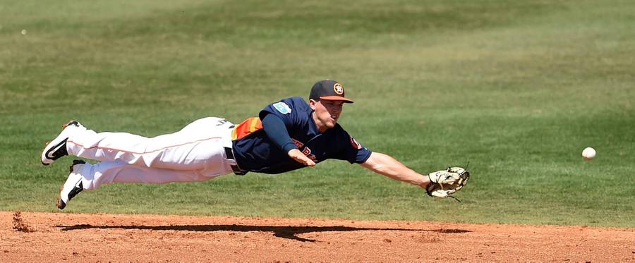 Alex Bregman of the Houston Astros dives for a ground ball during the third inning of a spring training game against the Washington Nationals at Osceola County Stadium  in Kissimmee, Florida, March 15, 2016. 