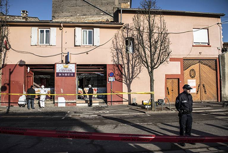 French police forensic scour the scene of an explosion at a kebab shop damaged following an explosion near a mosque, on January 8, 2015, in Villefranche-sur-Saone, eastern France. (JEAN-PHILIPPE KSIAZEK/AFP/Getty Images)