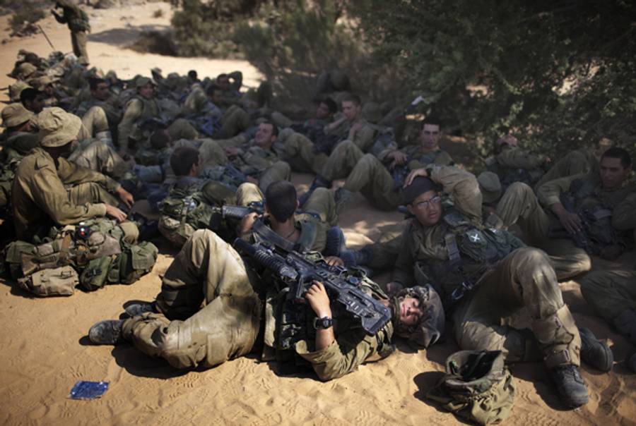 Israeli infantry soldiers of the Givati brigade rest during an open field combat exercise in the Israeli southern Negev desert near Ketziot army base on June 23, 2011.(Menahem Kahana/AFP/Getty Images)