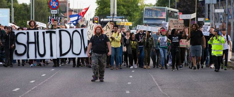 Protestors block the traffic by marching down Princess Parkway in Manchester, north west England after attending a Black Lives Matter event, on August 5, 2016. 