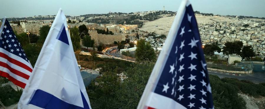 Israeli and U.S. flags flutter over the ramparts of Jerusalem's Old City as Israeli supporters of U.S. Republican presidential candidate Donald Trump gather for rally, October 26, 2016. 