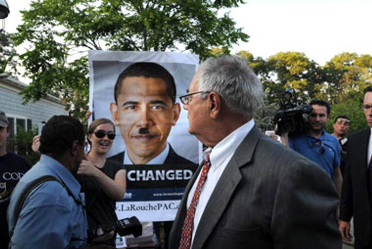 Rep. Barney Frank is confronted by a Obama-as-Hitler poster at a town hall meeting this summer.(Darren McCollester/Getty Images)
