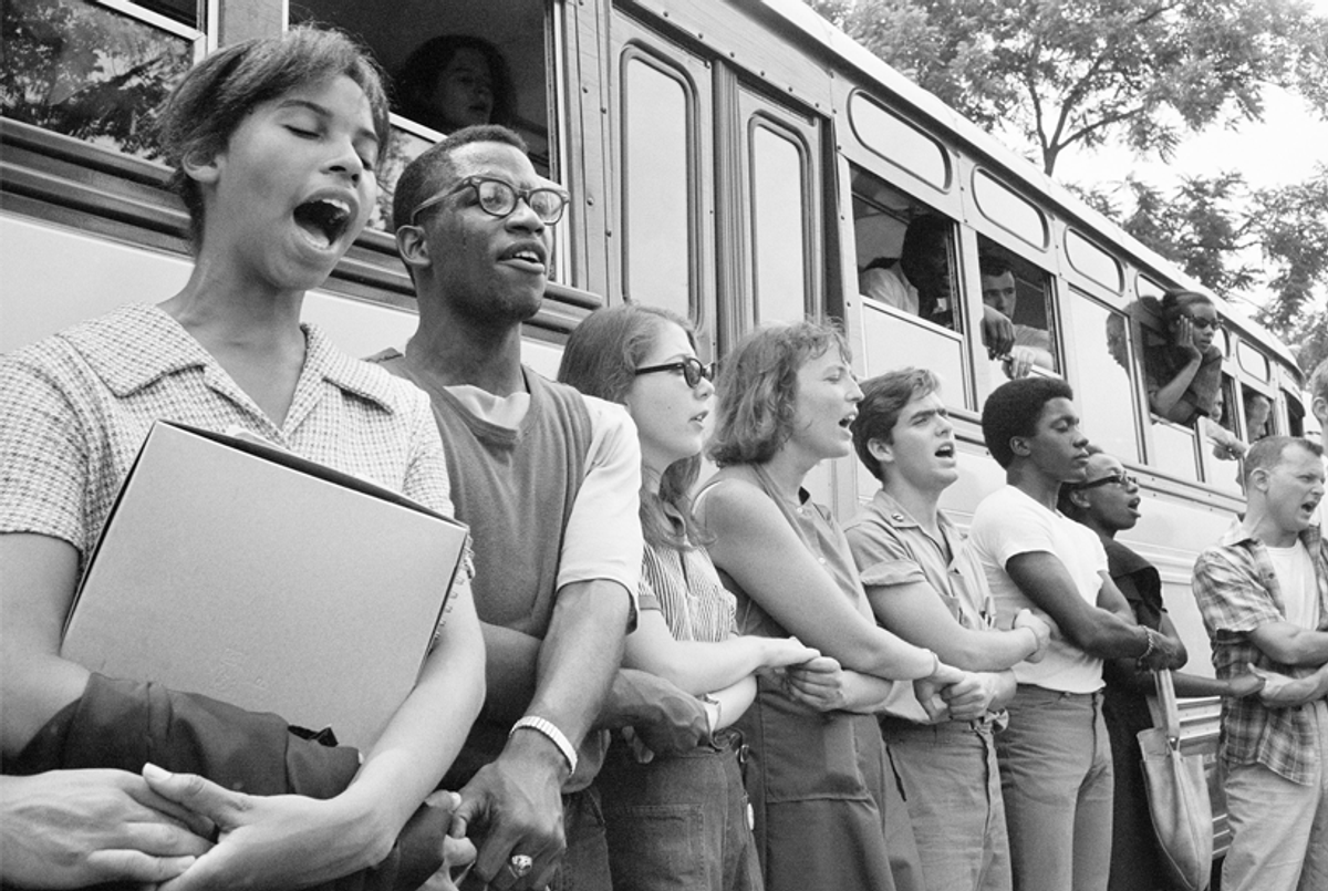 Student civil rights activists join hands and sing as they prepare to leave Ohio to register black voters in Mississippi during Freedom Summer 1964. (Ted Polumbaum/Newseum collection/PR Newswire)