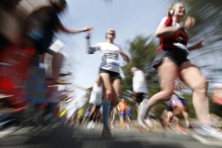 Boston Marathon runners passing through Wellesley, Mass., yesterday.