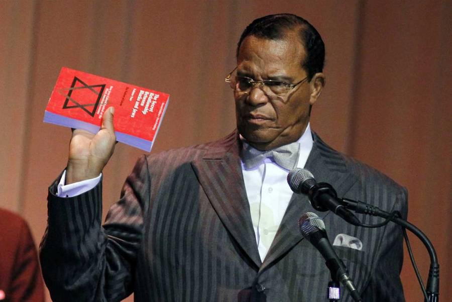 Minister Louis Farrakhan displays the book "The Secret Relationship Between Blacks and Jews" during his speech Friday, March 25, 2011, at Jackson State University in Jackson, Miss.