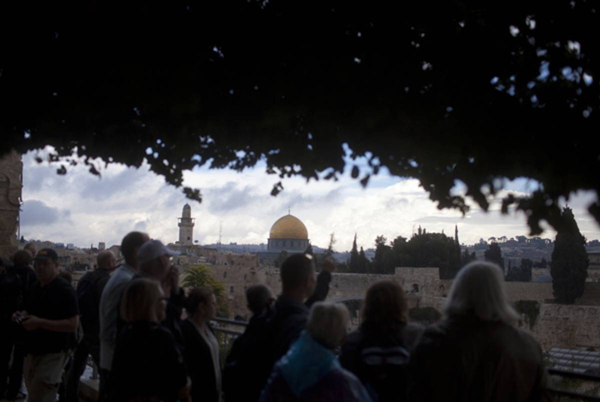 Tourists look at the Temple Mount compound from the Jewish quarter in Jerusalem's Old City on October 31, 2014. (Lior Mizrahi/Getty Images)