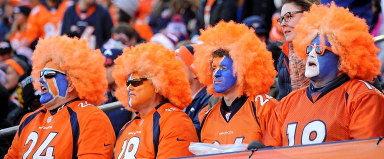 Denver Broncos fans with face paint and orange wigs watch during the AFC Divisional Playoff Game between the Denver Broncos and the Pittsburgh Steelers at Sports Authority Field at Mile High on January 17, 2016 in Denver, Colorado. 