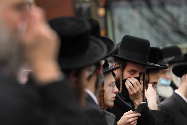Hundreds of members of an Orthodox Jewish community attend the funeral for a rabbi who died from the coronavirus in the Borough Park neighborhood of Brooklyn, on April 5, 2020