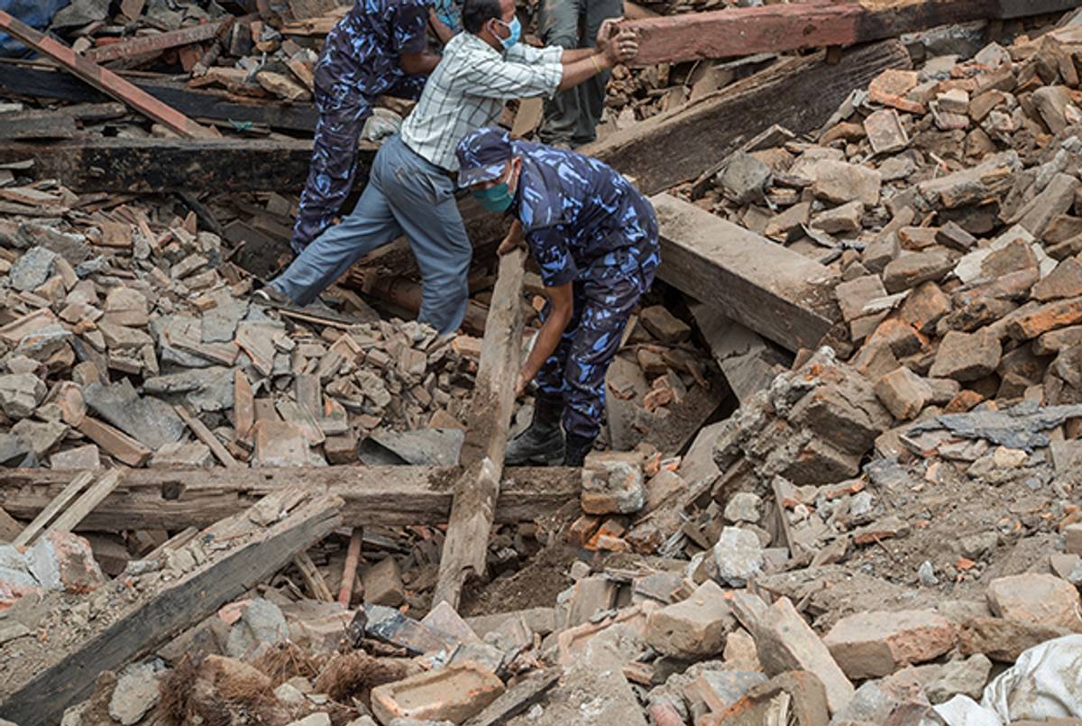 Volunteers and emergency workers search for bodies buried under debris on April 27, 2015 in Kathmandu, Nepal. (Omar Havana/Getty Images)