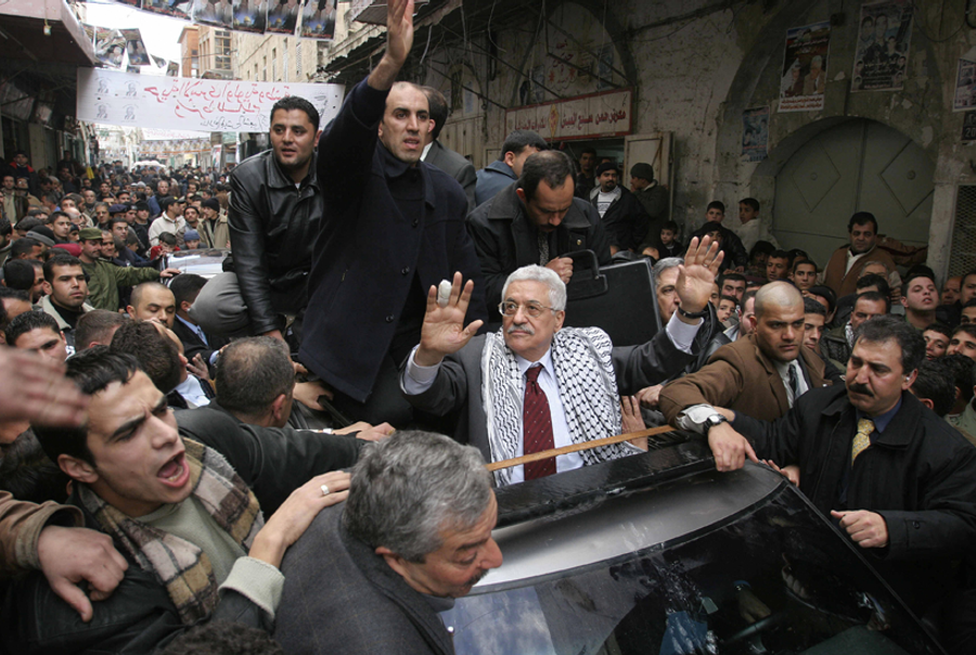Mahmoud Abbas waves to the crowd during a visit to Nablus on Jan. 6, 2005. (Pedro Ugarte/AFP/Getty Images)