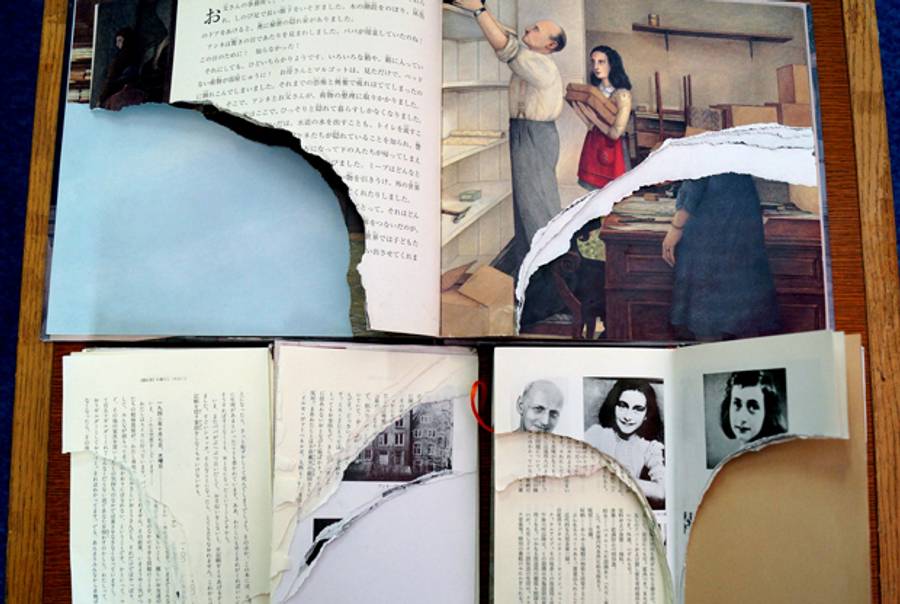 Ripped pages of three books of Anne Frank's 'Diary of Young Girl' are displayed at a library in Tokyo on February 21, 2014. (JIJI PRESS/AFP/Getty Images)