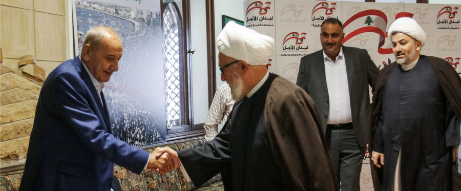 Longtime Lebanese Parliament Speaker Nabih Berri (left) receives incoming Shiite clerics arriving to greet him in his home in Msaileh, south of the southern port city of Sidon, on May 8, 2018.