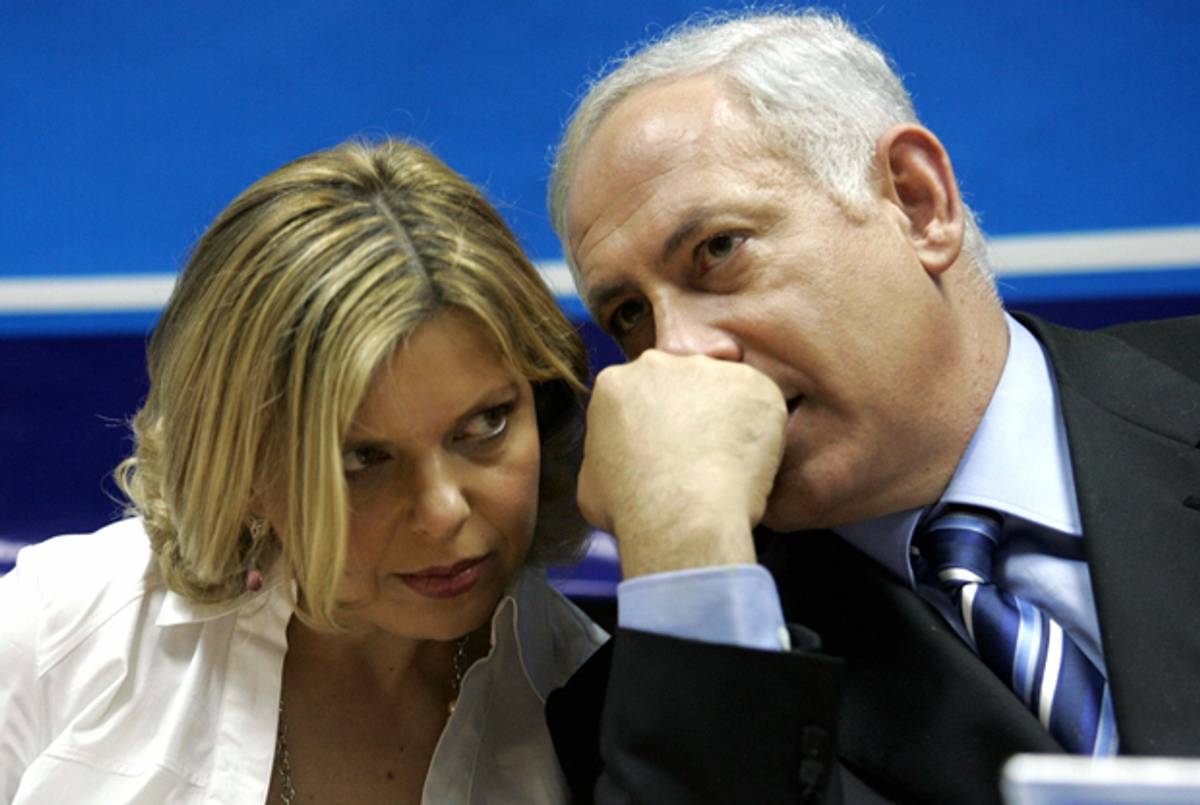 Benjamin Netanyahu talks to his wife, Sara, during a pre-election rally at the Likud headquarters in Tel Aviv, March 2006.(Gali Tibbon/AFP/Getty Images)
