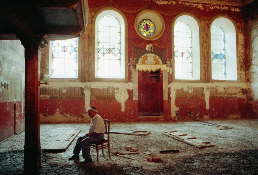 An elderly man sits in an abandoned synagogue, Russia, 1991