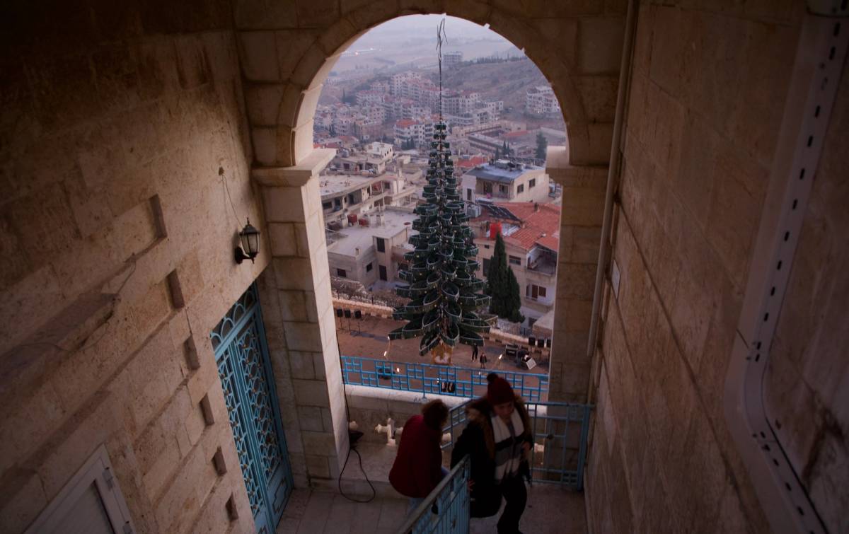 Christians gather for the lighting of a Christmas tree at the Monastery of Our Lady of Saydnaya square on Dec. 24, 2024, in Saydnaya, Syria