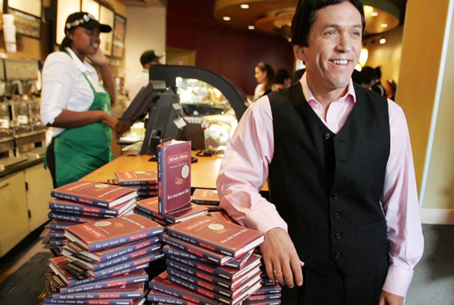Author Mitch Albom poses with copies of his new book For One More Day at a Starbucks store Oct. 3, 2006 in New York City.(Mario Tama/Getty Images)