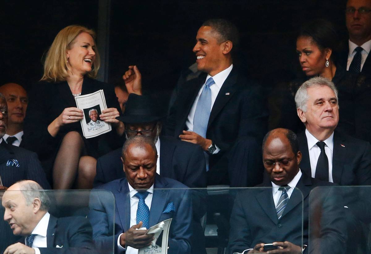 President Barack Obama jokes with Danish prime minister, Helle Thorning-Schmidt, left, as first lady Michelle Obama looks on at right during the memorial service for former South African president Nelson Mandela at the FNB Stadium in Soweto, South Africa, 2013