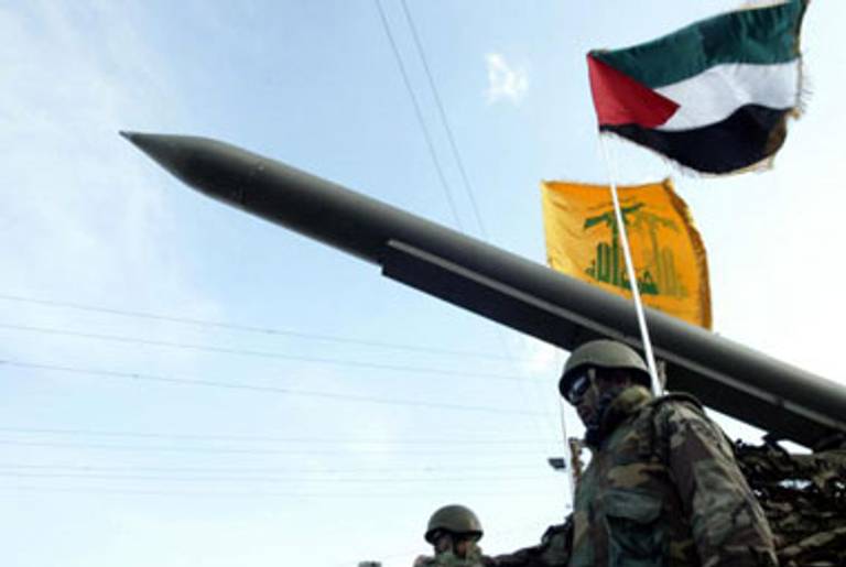 Hezbollah militants parade with a missile(Mahmoud Zayat/AFP/Getty Images)