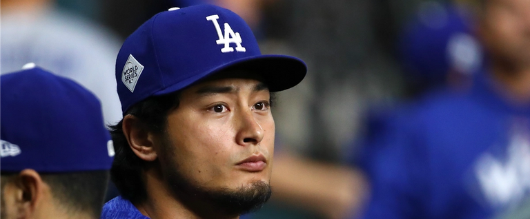 Yu Darvish #21 of the Los Angeles Dodgers looks on from the dugout before game four of the 2017 World Series against the Houston Astros at Minute Maid Park on October 28, 2017 in Houston, Texas.