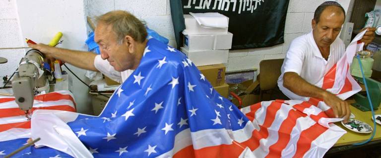 Israeli workers put the finishing touches on an American flag at the Marom flag factory in the central Israeli town of Rosh Ha'Ayin, Sept. 17, 2001.