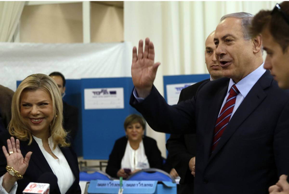 Israeli Prime Minister Benjamin Netanyahu and his wife Sara after voting at a polling station for the Likud party primaries on December 31, 2014 in Jerusalem. (GALI TIBBON/AFP/Getty Images)
